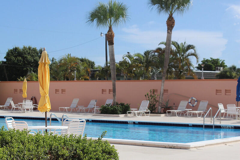 1351 Bayshore Drive, Unit 304 Fort Pierce, FL 34949 - Photo 19 of 25 a view of a lake with a table and chairs