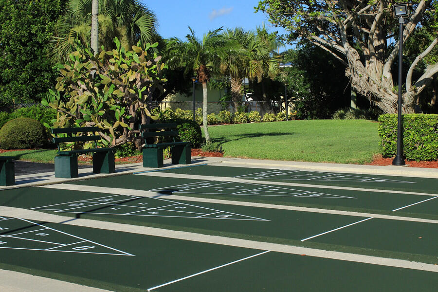 1351 Bayshore Drive, Unit 304 Fort Pierce, FL 34949 - Photo 20 of 25 a view of a tennis ground with large trees