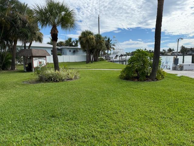 1351 Bayshore Drive, Unit 304 Fort Pierce, FL 34949 - Photo 24 of 25 a front view of a house with a yard and palm trees