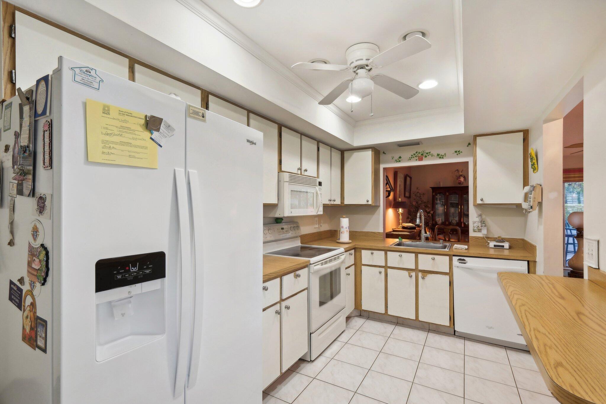 125 Wandering Trail, Unit TRL Jupiter, FL 33458 - Photo 13 of 22 a kitchen with stainless steel appliances a refrigerator sink and cabinets