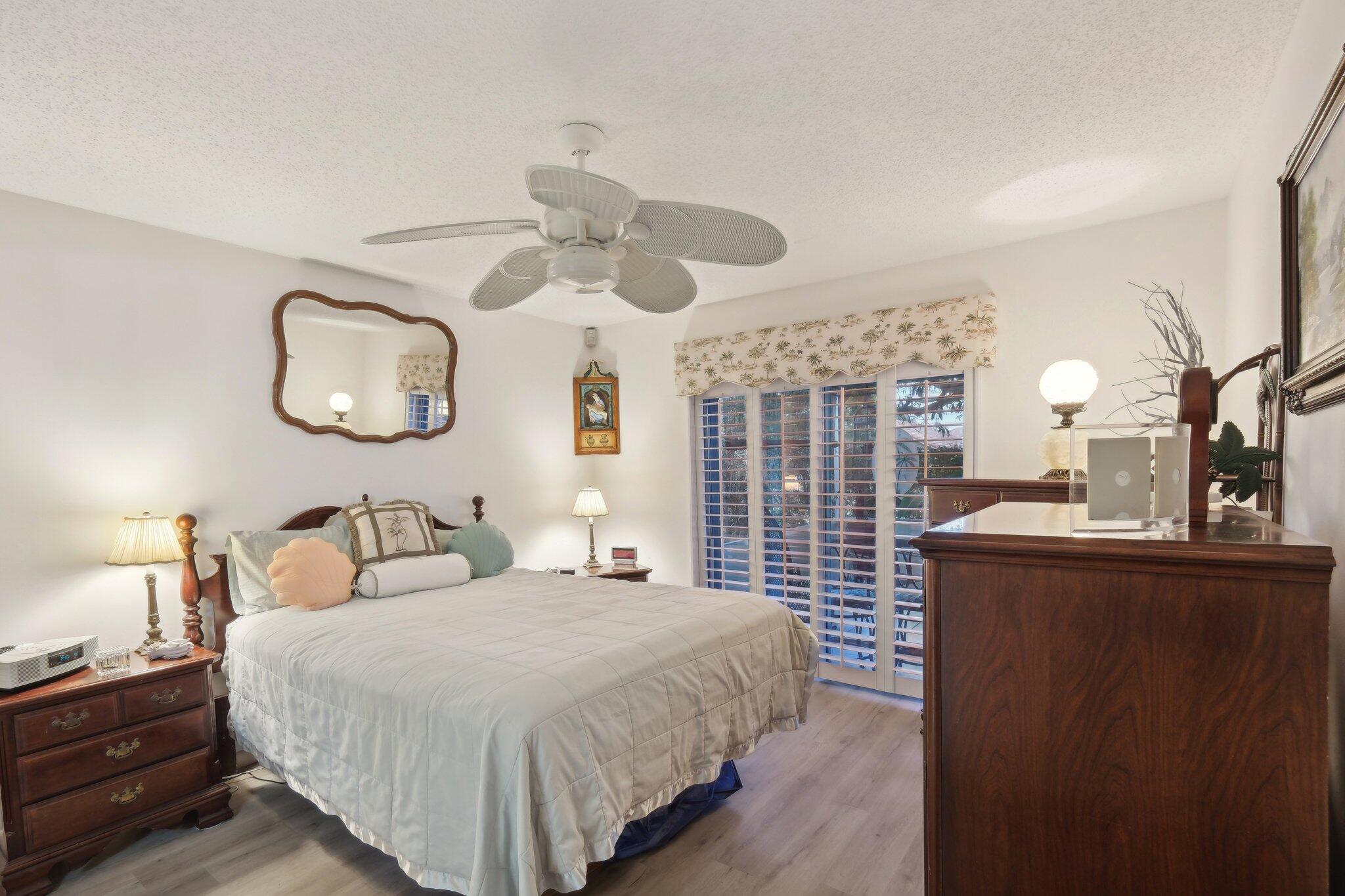 125 Wandering Trail, Unit TRL Jupiter, FL 33458 - Photo 14 of 22 a bedroom with a bed and window