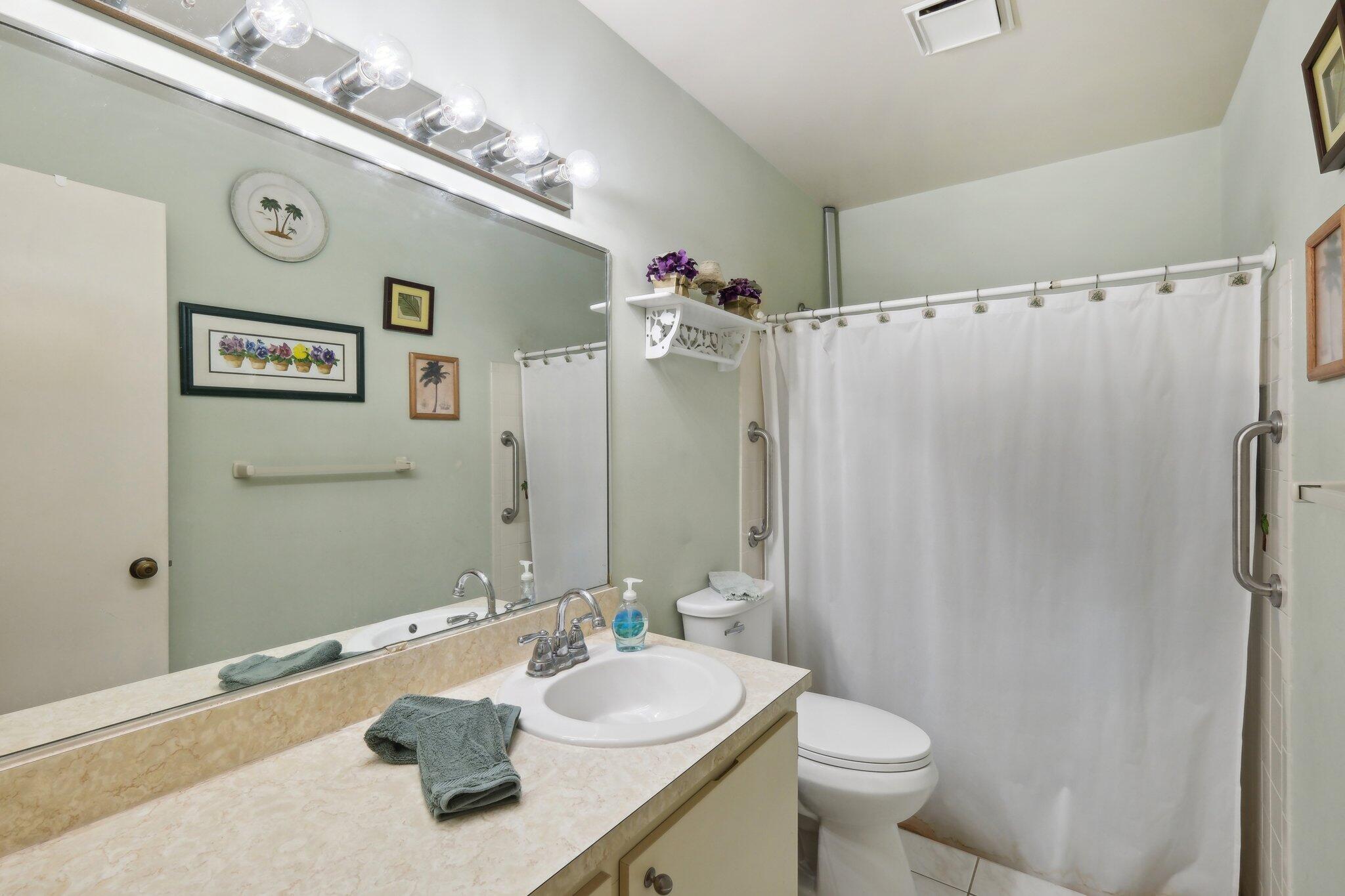 125 Wandering Trail, Unit TRL Jupiter, FL 33458 - Photo 17 of 22 a bathroom with a sink vanity mirror and toilet
