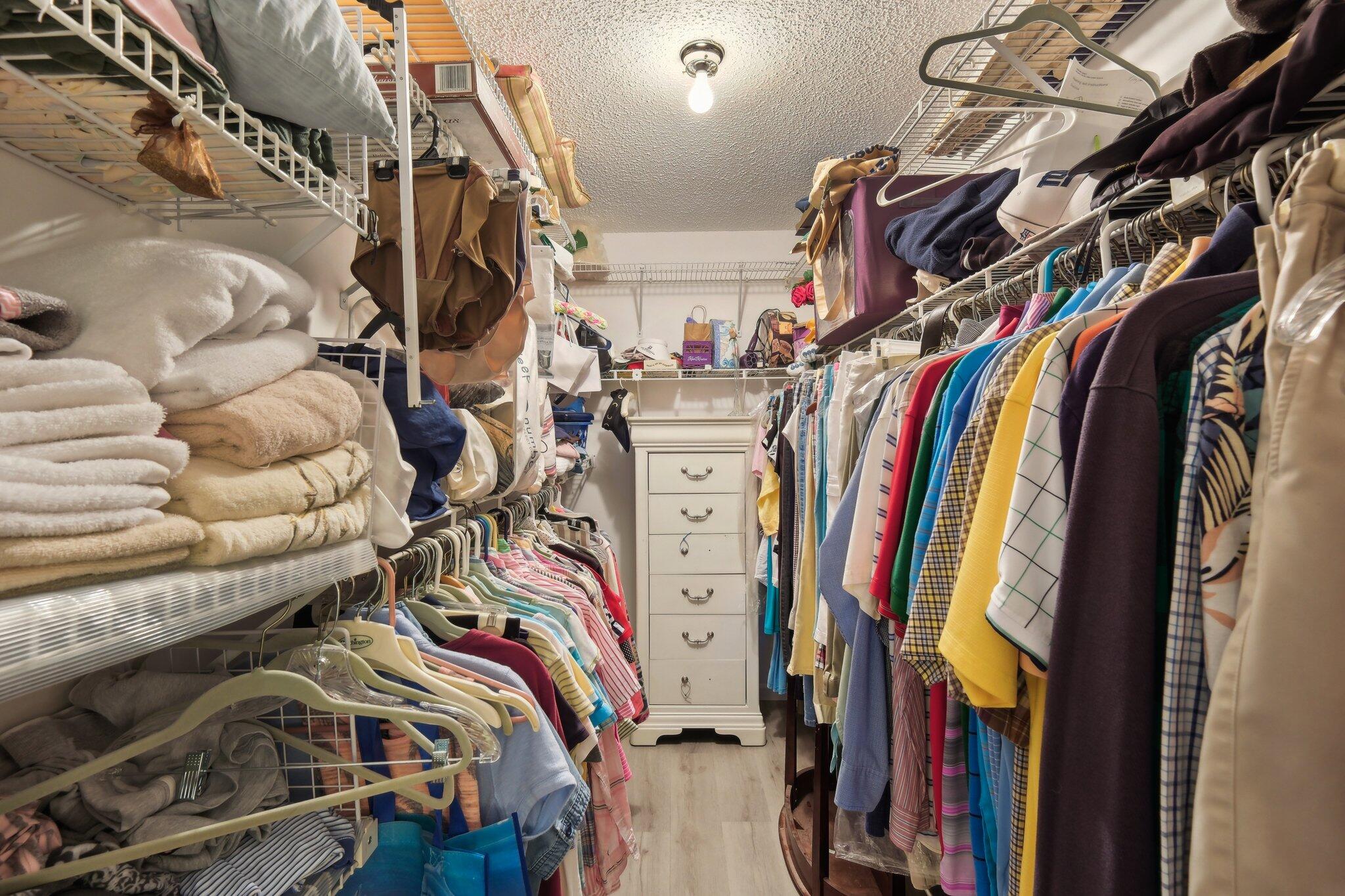 125 Wandering Trail, Unit TRL Jupiter, FL 33458 - Photo 18 of 22 a view of walk in closet with clothes