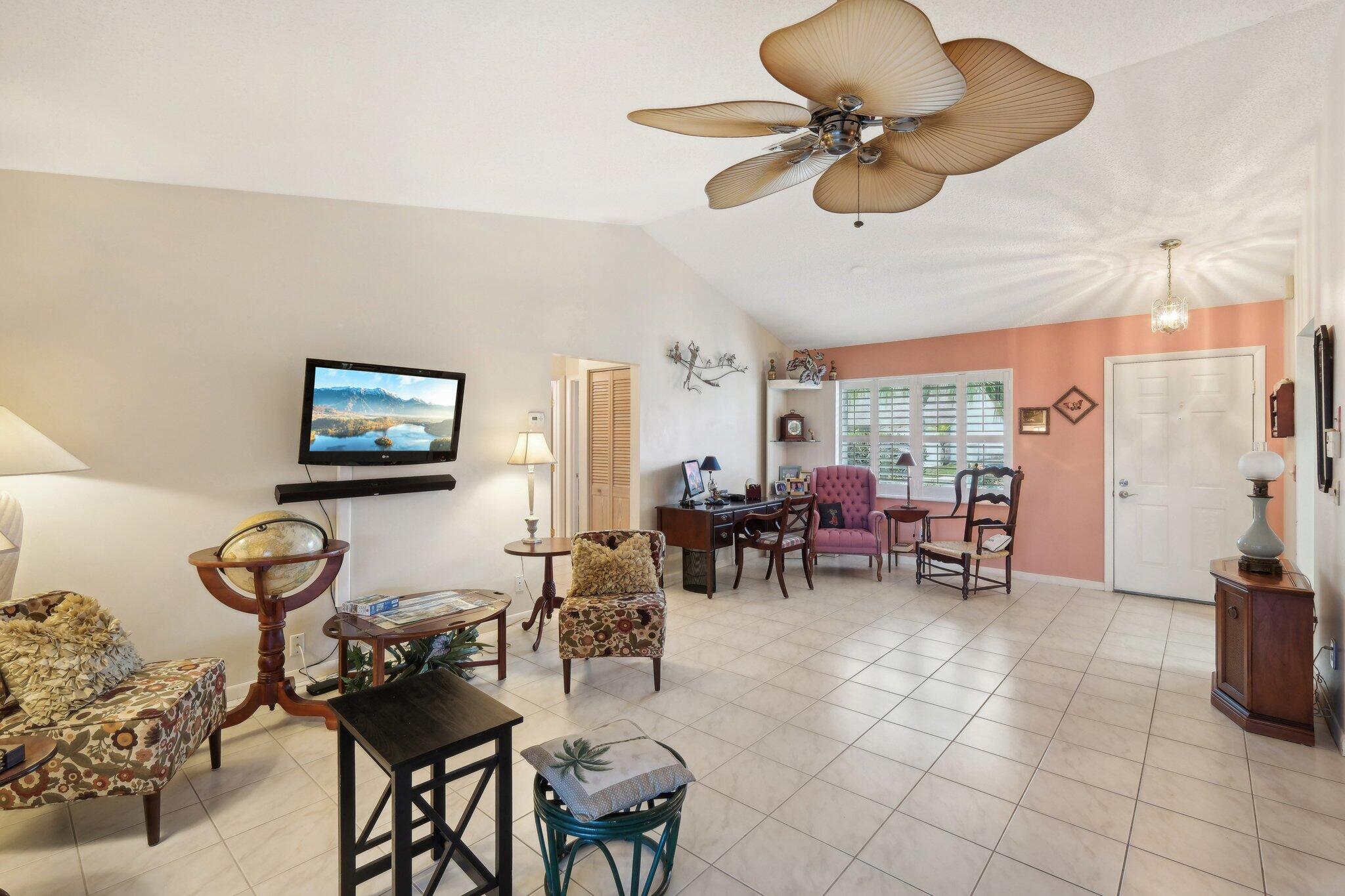 125 Wandering Trail, Unit TRL Jupiter, FL 33458 - Photo 4 of 22 a view of a livingroom with furniture and a chandelier