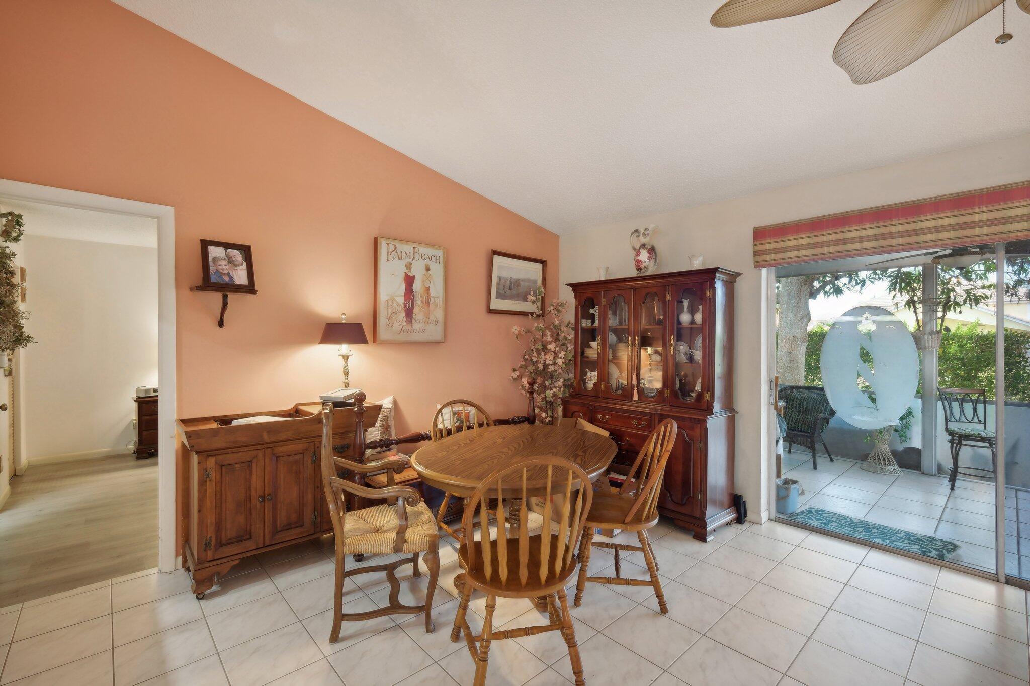125 Wandering Trail, Unit TRL Jupiter, FL 33458 - Photo 7 of 22 a view of a dining room with furniture and chandelier