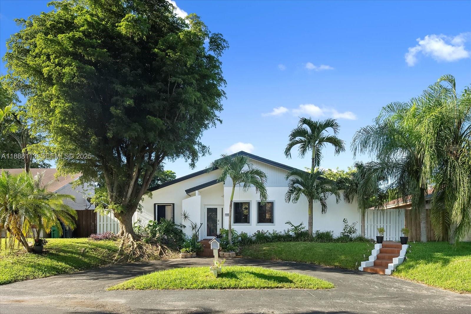 13556 Southwest 285th Terrace Homestead, FL 33033 - Photo 1 of 25 a front view of a house with garden