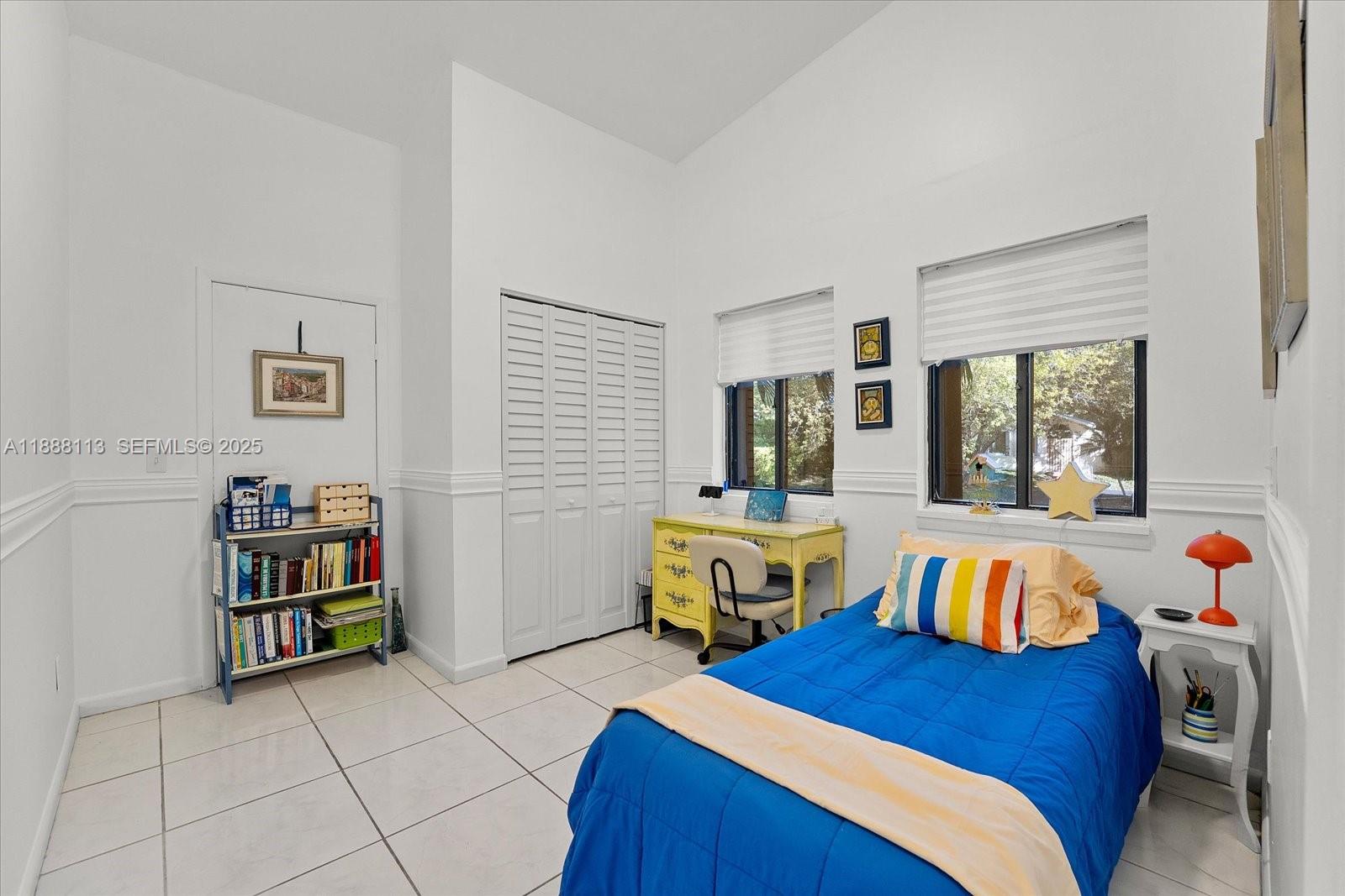 13556 Southwest 285th Terrace Homestead, FL 33033 - Photo 16 of 25 a bedroom with a bed and a book shelf