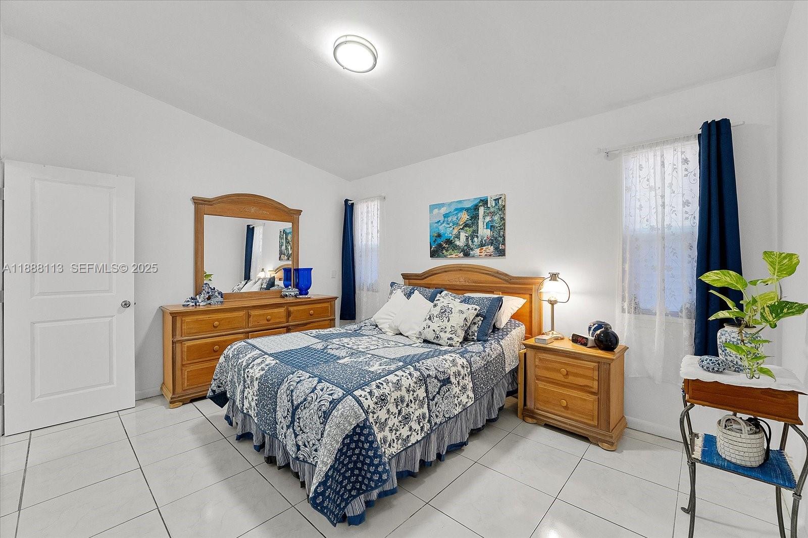 13556 Southwest 285th Terrace Homestead, FL 33033 - Photo 18 of 25 a bedroom with a bed and a potted plant on the dresser