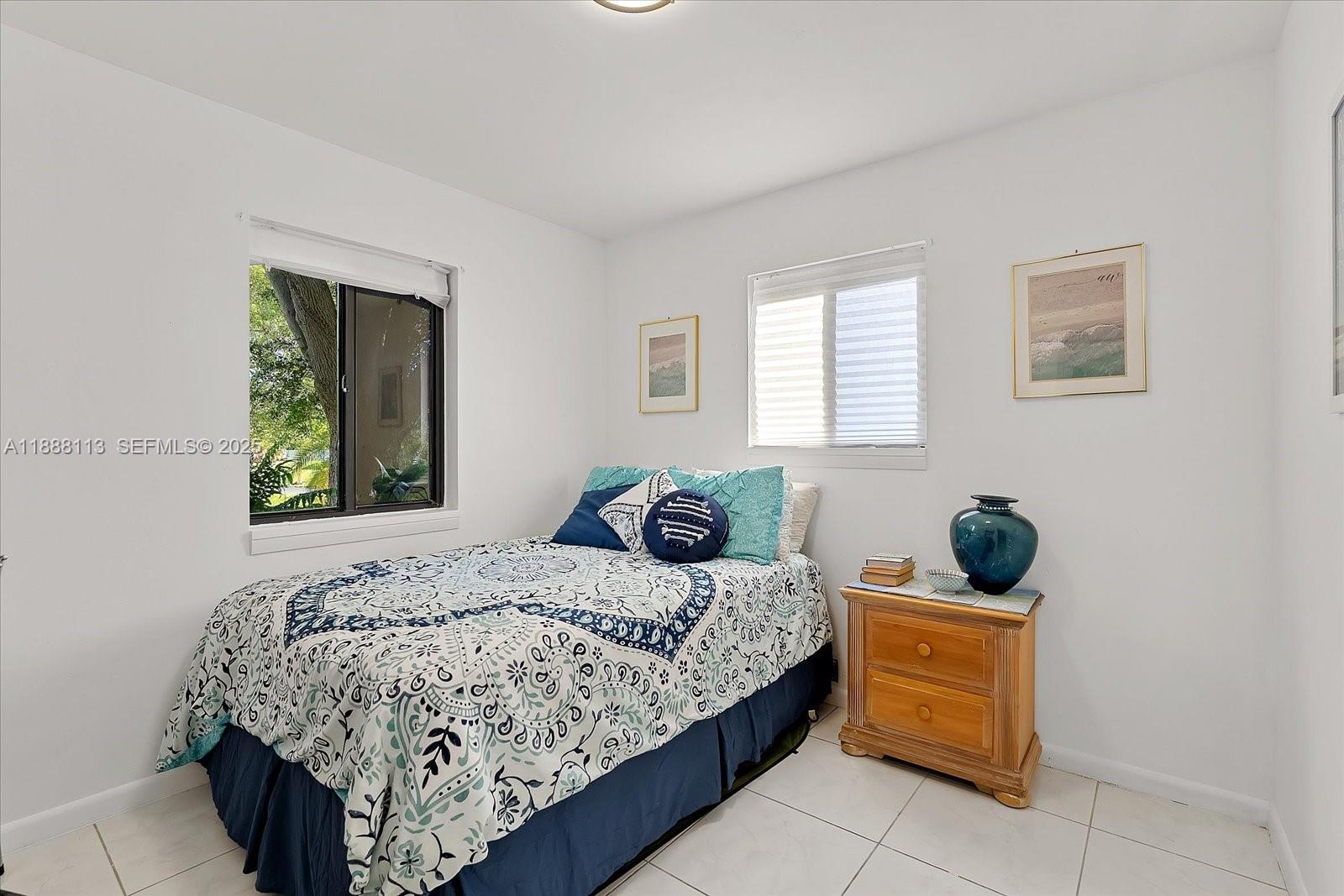 13556 Southwest 285th Terrace Homestead, FL 33033 - Photo 20 of 25 a bedroom with a bed and window