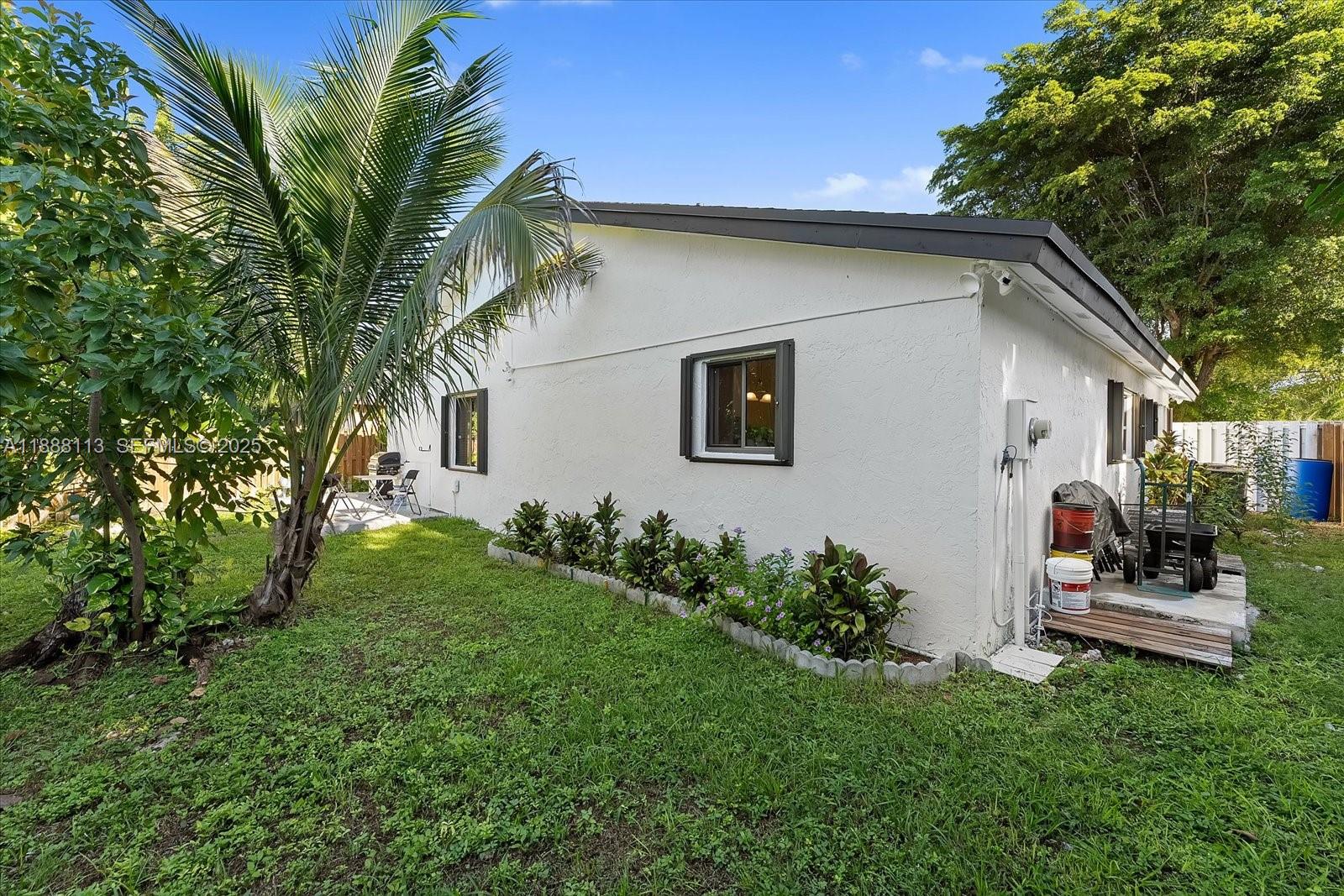 13556 Southwest 285th Terrace Homestead, FL 33033 - Photo 22 of 25 a backyard of a house with seating space
