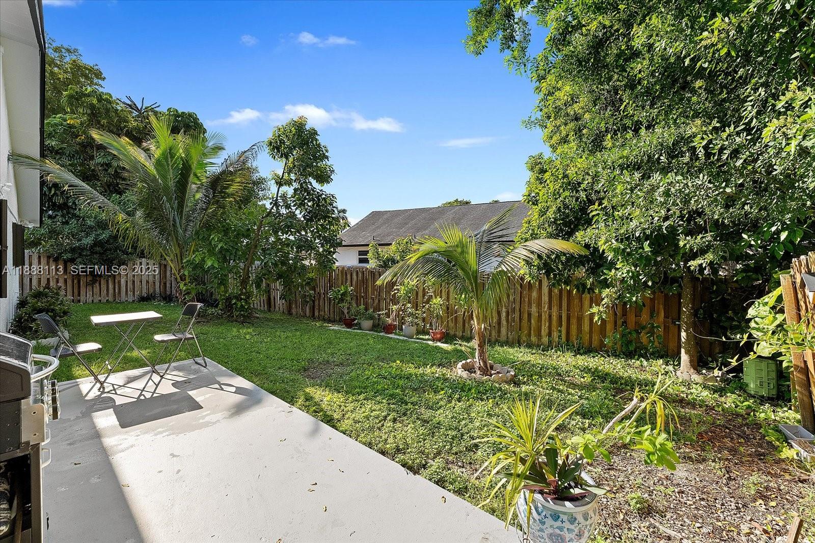 13556 Southwest 285th Terrace Homestead, FL 33033 - Photo 24 of 25 a view of a garden with a large tree in it