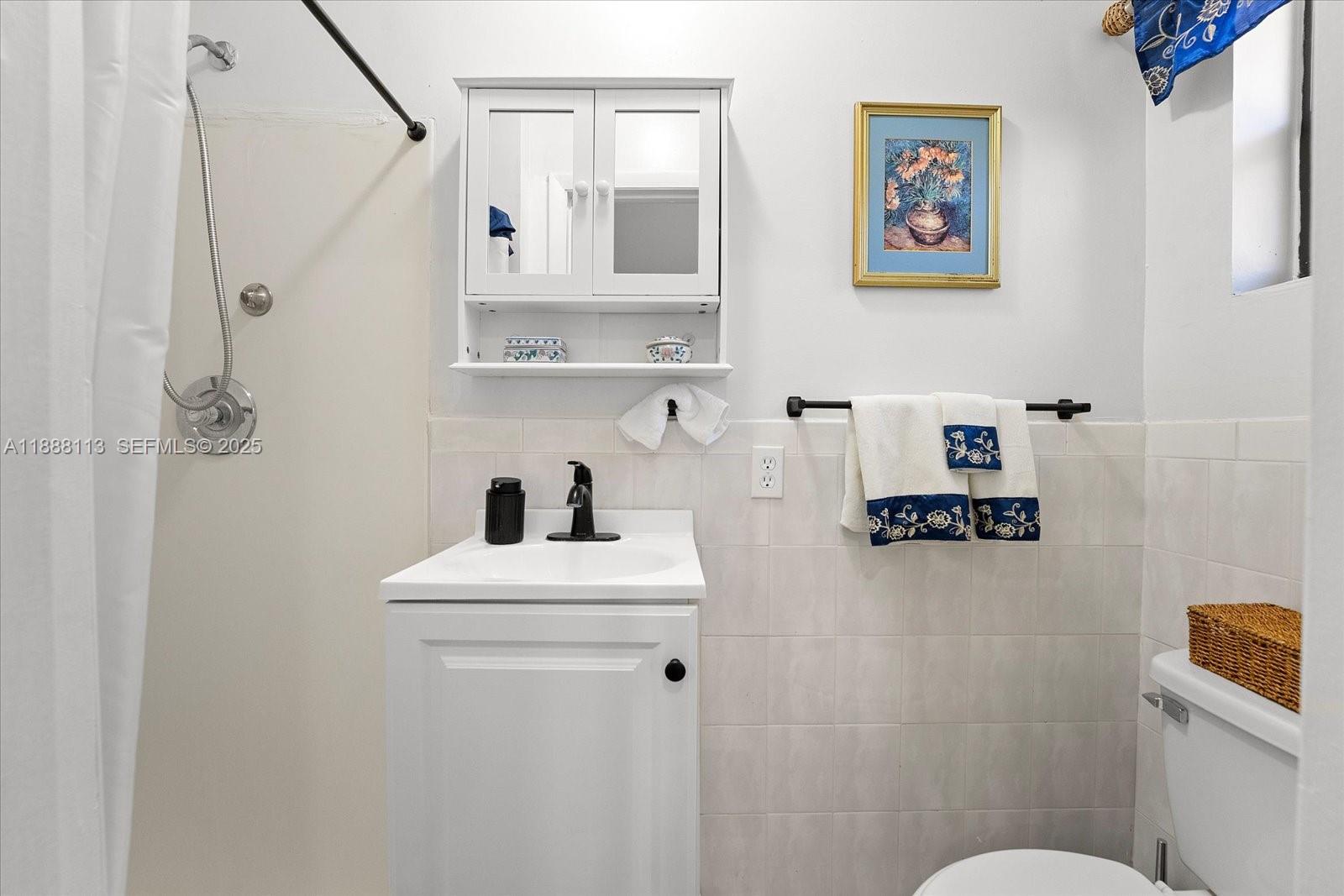 13556 Southwest 285th Terrace Homestead, FL 33033 - Photo 9 of 25 a bathroom with a sink mirror and toilet