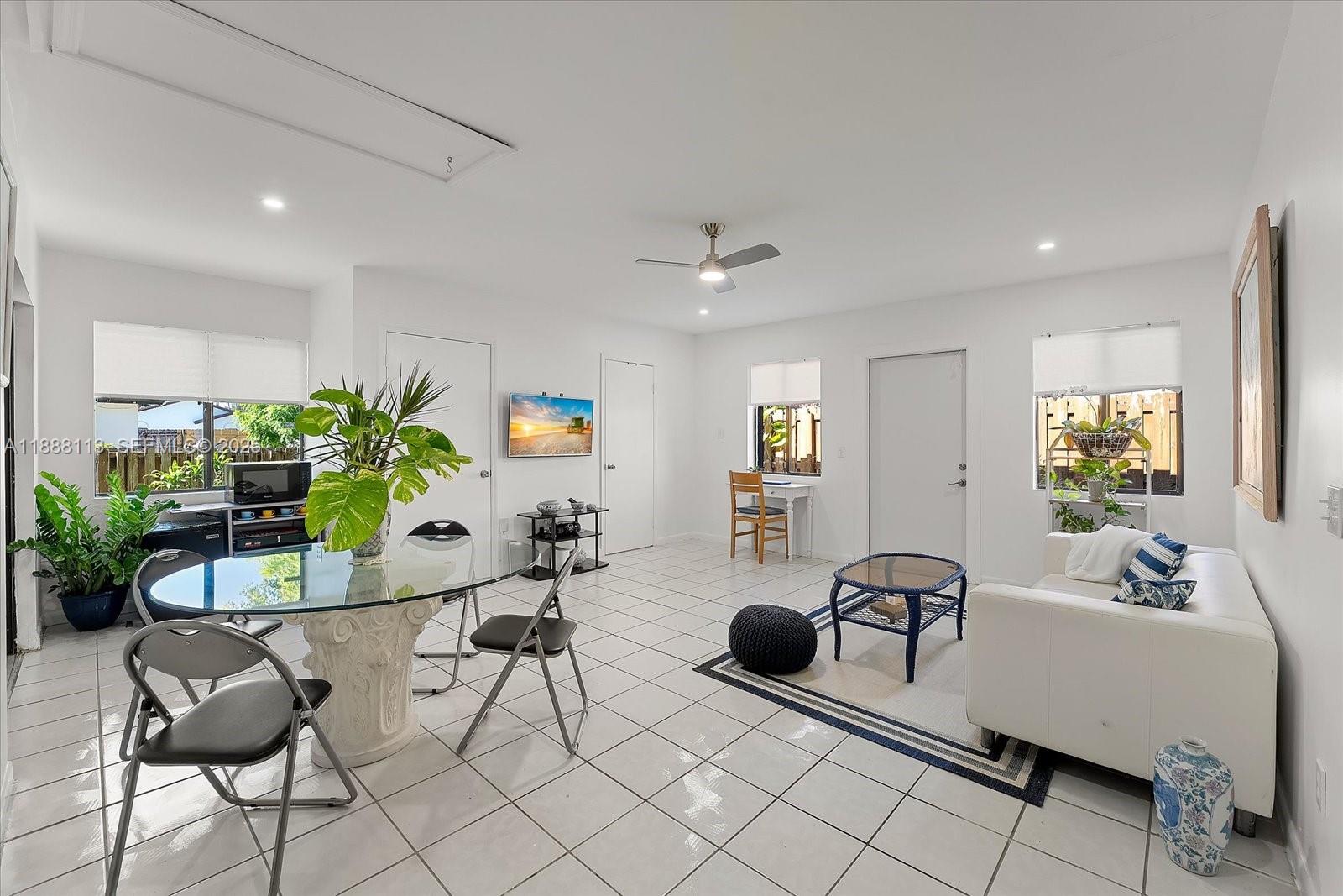 13556 Southwest 285th Terrace Homestead, FL 33033 - Photo 10 of 25 a living room with furniture a dining table and a potted plant