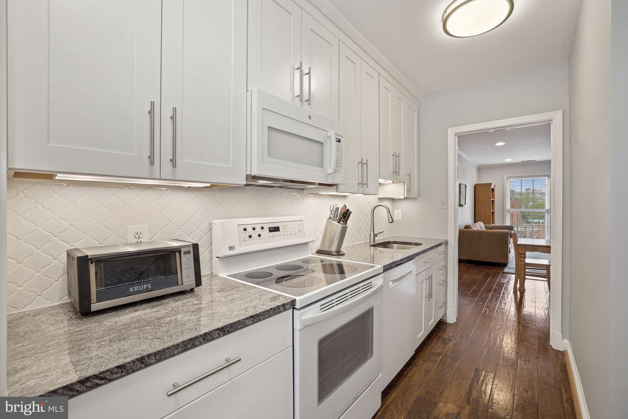 1650 Beekman Place Northwest, Unit A Washington, DC 20009 - Photo 7 of 25 Granite, backsplash, & under-cabinet lighting