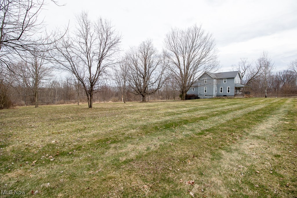5693 South Ridge Road Madison, OH 44057 - Photo 2 of 45 Side yard to the left of the home. The yard is fully fenced