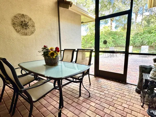 a view of a dining room with furniture and window