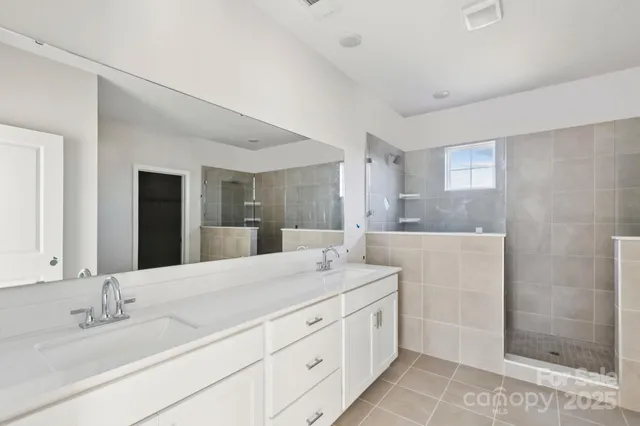 a bathroom with a granite countertop sink mirror and shower