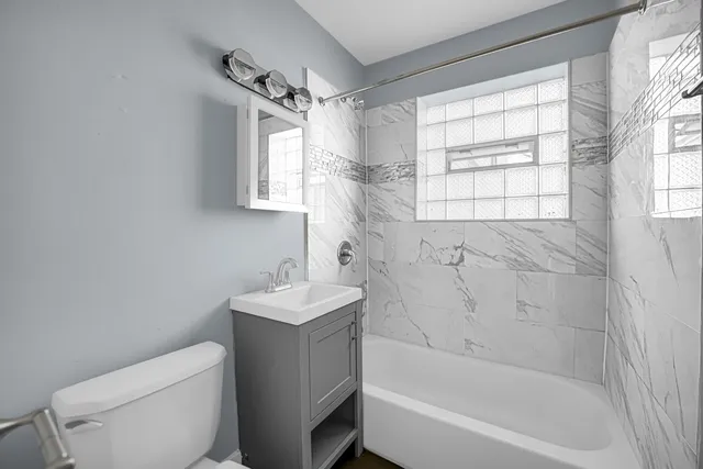 a bathroom with a bathtub toilet and sink