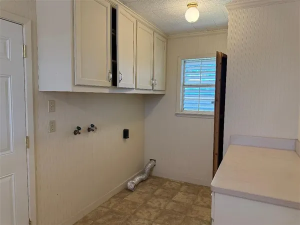a view of storage and utility room with closet