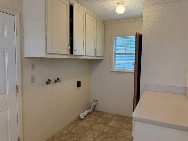 a view of storage and utility room with closet