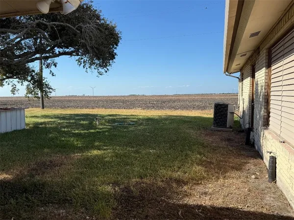 a view of a big yard with an outdoor seating