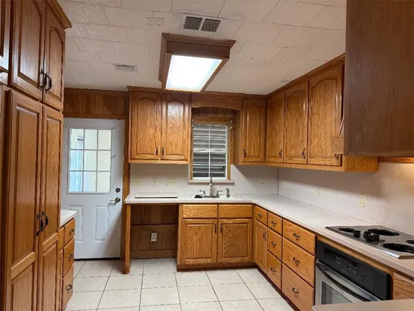 a kitchen that has a sink and a stove