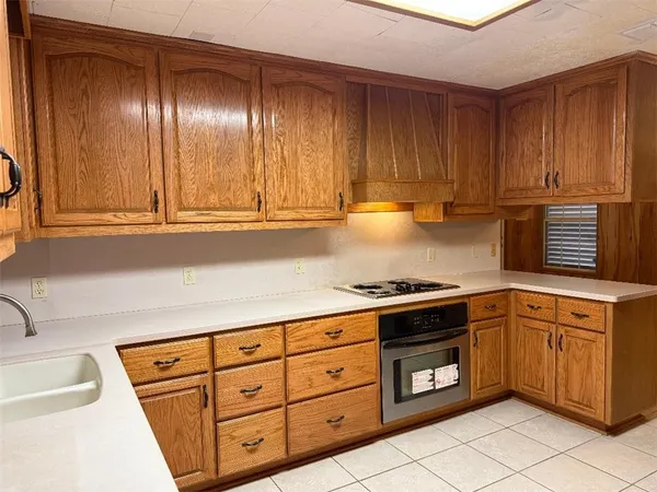 a kitchen with granite countertop cabinets and stainless steel appliances