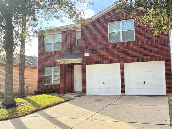a view of a brick house with a large window