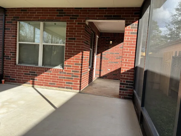 a view of backyard with two large windows