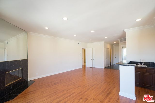 a view of a kitchen with a sink and a stove top oven