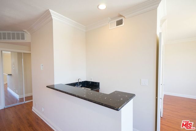 a close view of kitchen island with granite countertop