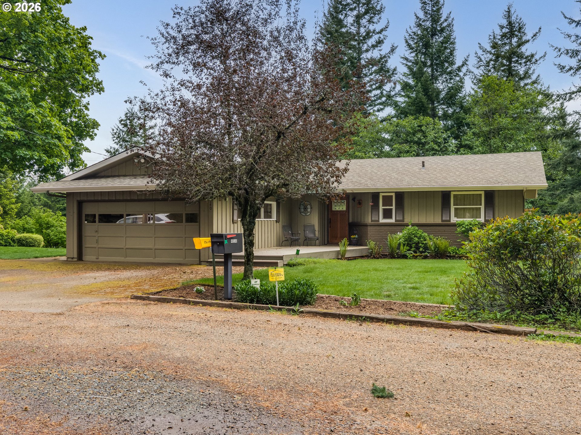 48140 Southeast Linhart Butte Road Sandy, OR 97055 - Photo 2 of 47 a front view of a house with a yard and garage