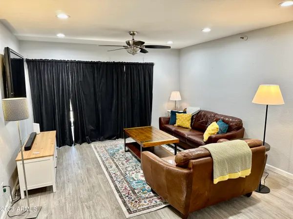 a living room with furniture and a lamp