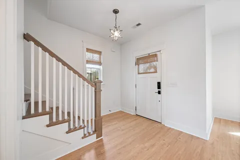 a view of an entryway with wooden floor