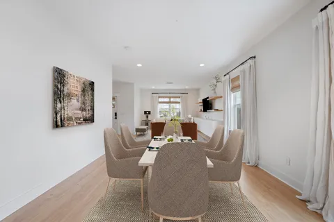 a living room with furniture a flat screen tv and a wall painting