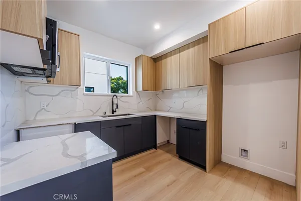 a kitchen with stainless steel appliances granite countertop a sink stove and cabinets