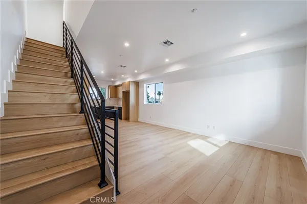 a view of entryway with wooden floor and stairs