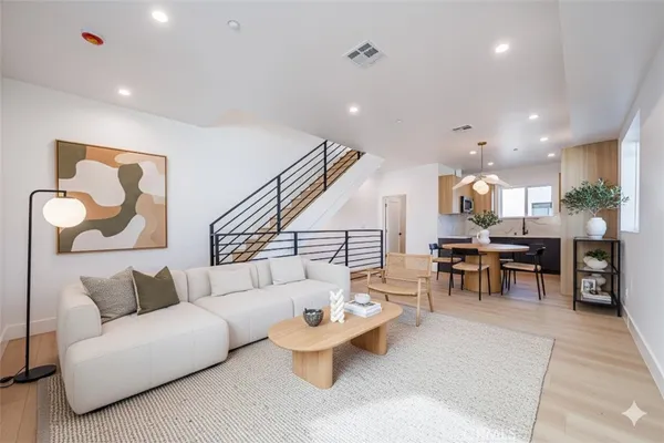 a living room with furniture and kitchen view