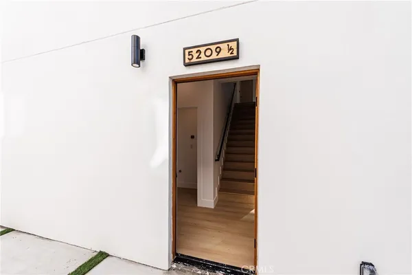 a view of a hallway with wooden floor