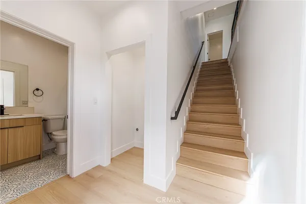a view of an entryway with wooden floor and a bathroom