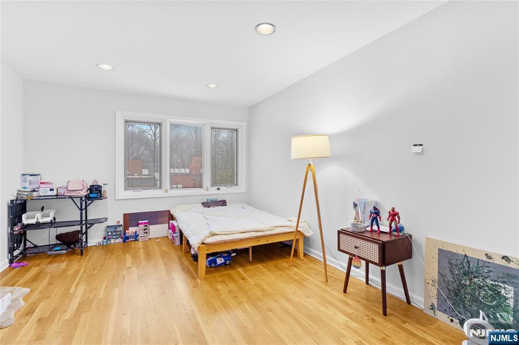 55 Hidden Ledge Road Englewood, NJ 07631 - Photo 12 of 22 a bed room with a bed and a window