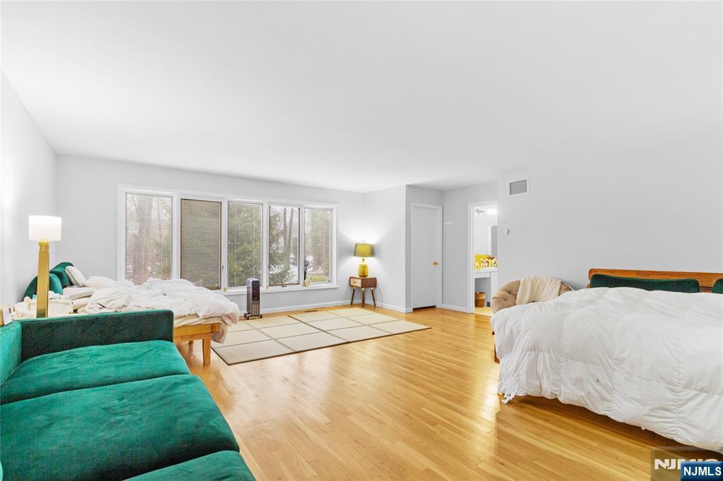 55 Hidden Ledge Road Englewood, NJ 07631 - Photo 13 of 22 a large bedroom with a bed and window