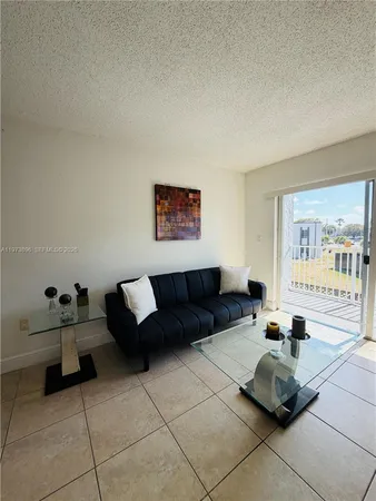 a living room with furniture and a mirror