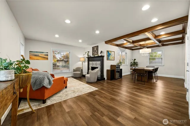 a living room with fireplace furniture and a wooden floor