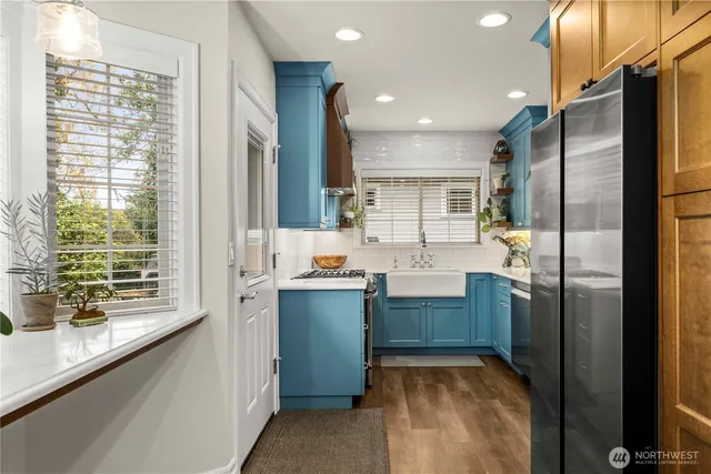 a kitchen with stainless steel appliances granite countertop a refrigerator and a sink