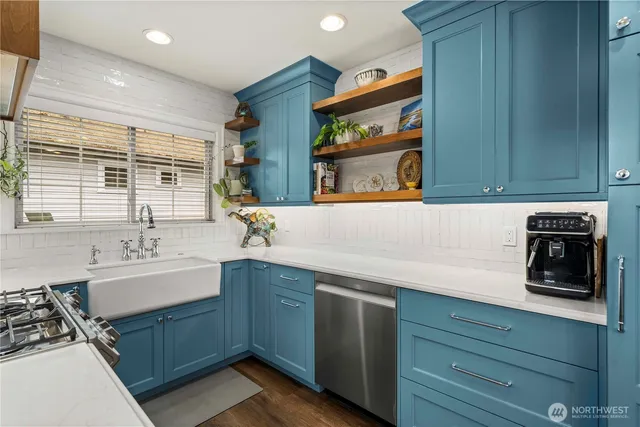a kitchen with stainless steel appliances a sink stove and cabinets
