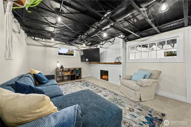 a living room with furniture and a fireplace