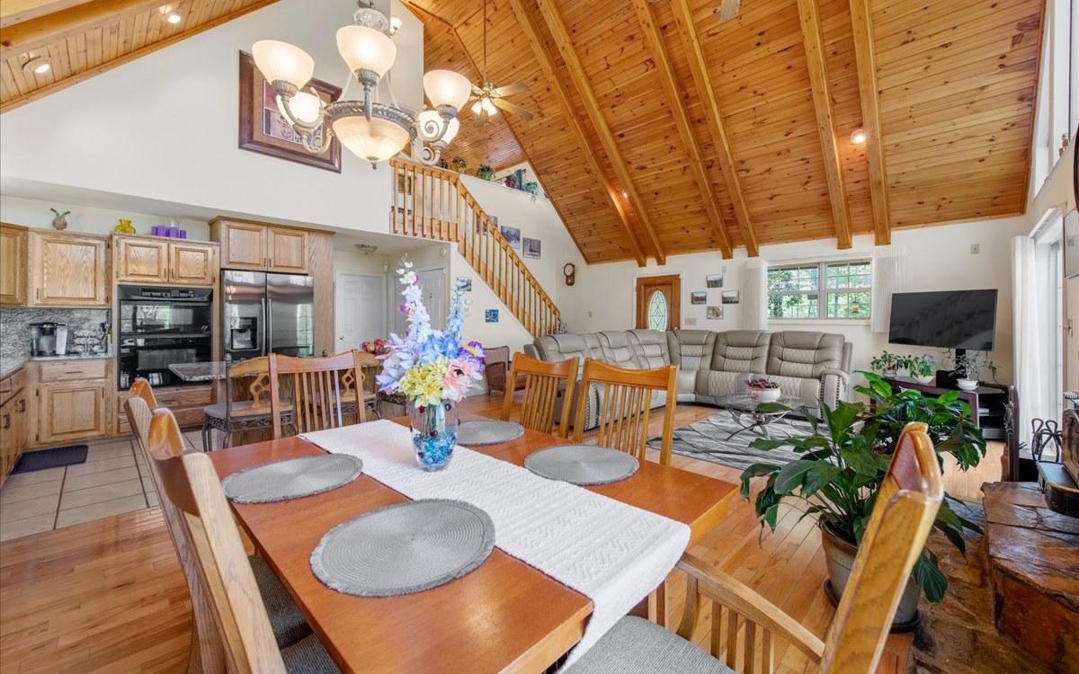94 Mull Ln Circle Morganton, GA 30560 - Photo 27 of 67 a view of a dining room with furniture one side kitchen view and wooden floor