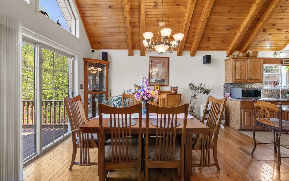 94 Mull Ln Circle Morganton, GA 30560 - Photo 29 of 67 a view of a dining room with furniture wooden floor and chandelier