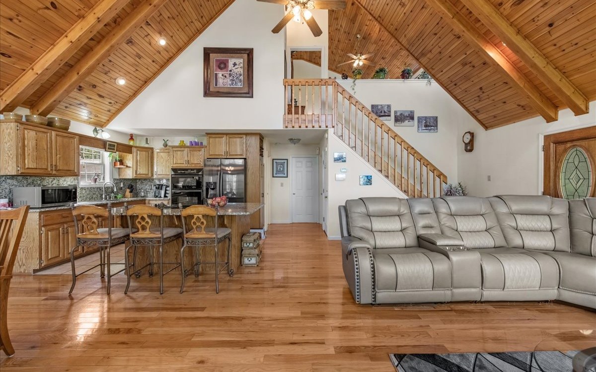 94 Mull Ln Circle Morganton, GA 30560 - Photo 30 of 67 a living room with couches and kitchen view with wooden floor
